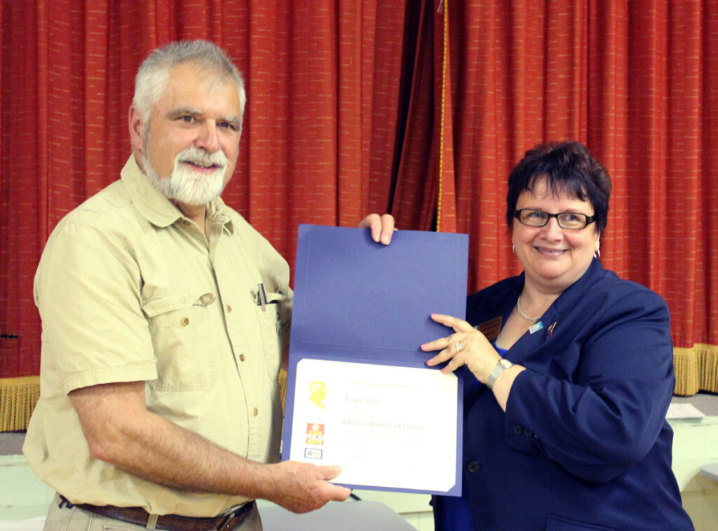 Rebecca MacPherson, Rotary International District Governor, presenting Eagle Walz with the Paul Harris Fellow Award, in 2012